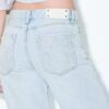 Calças de ganga de cintura baixa e perna Wide Leg com detalhe de estrela Calças de ganga de cintura baixa e perna Wide Leg com detalhe de estrela
