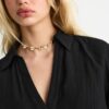 Camisa esvoaçante com botões Camisa esvoaçante com botões